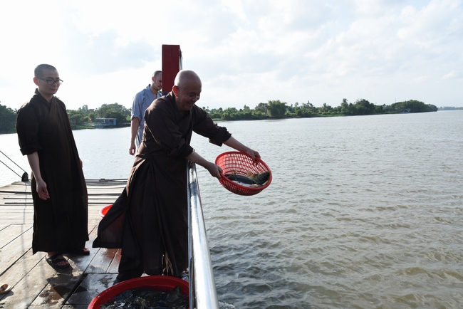 Praying for rebirth and releasing creatures in Ba Lua port, Cu Chi